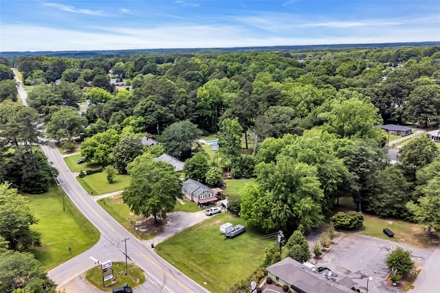 drone / aerial view with a wooded view