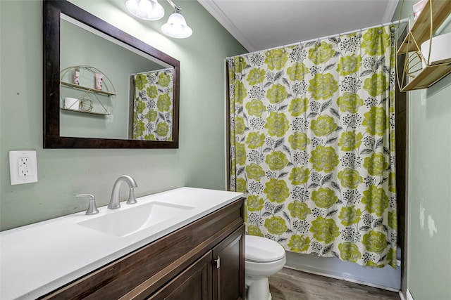 full bath with toilet, ornamental molding, wood finished floors, shower / bathtub combination with curtain, and vanity