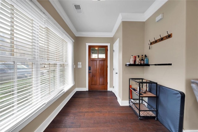 entrance foyer with dark wood-style floors, visible vents, crown molding, and baseboards