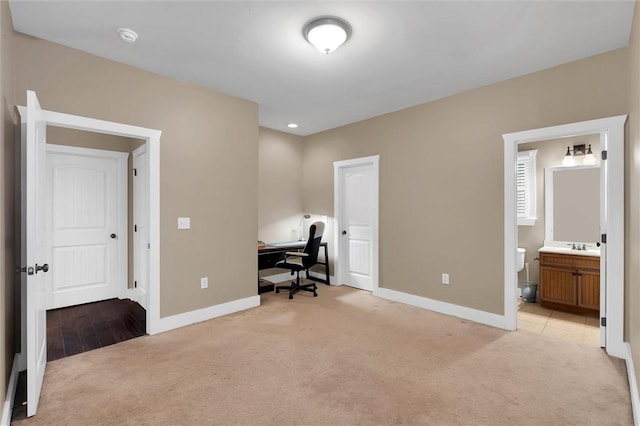 home office with light carpet and baseboards