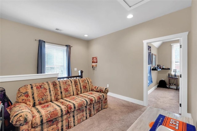 carpeted living room with plenty of natural light, visible vents, baseboards, and recessed lighting