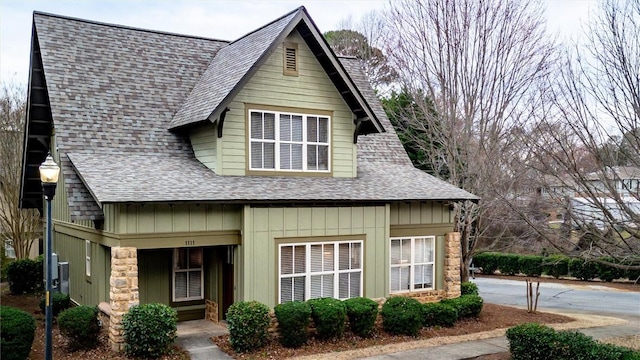 view of front facade featuring a shingled roof and board and batten siding