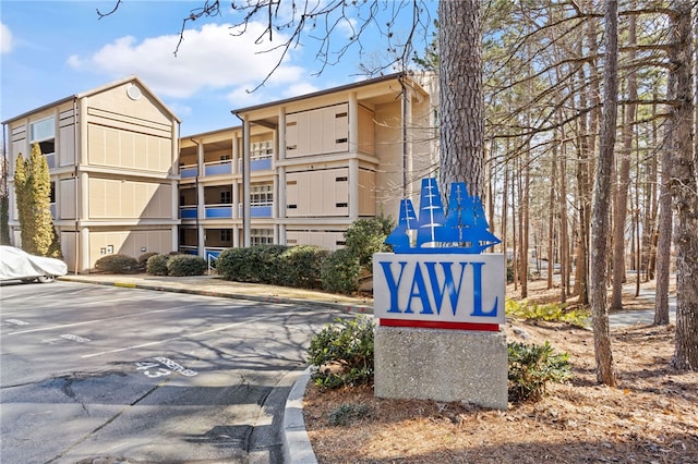 view of building exterior featuring uncovered parking