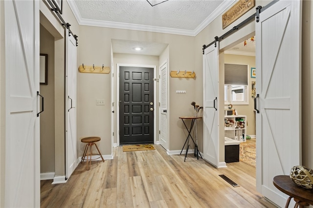 495TALLSHIP240 Tall Ship Dr, Salem, SC 29676 - foyer with a barn door, light wood finished floors, baseboards, ornamental molding, and a textured ceiling