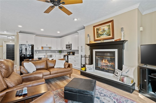 495TALLSHIP240 Tall Ship Dr, Salem, SC 29676 - living area featuring light wood-style floors, ornamental molding, ceiling fan, a glass covered fireplace, and recessed lighting