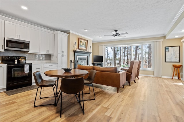 495TALLSHIP240 Tall Ship Dr, Salem, SC 29676 - dining area featuring ornamental molding, light wood-style flooring, a glass covered fireplace, a textured ceiling, and recessed lighting