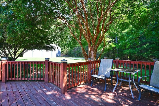 wooden deck with a lawn