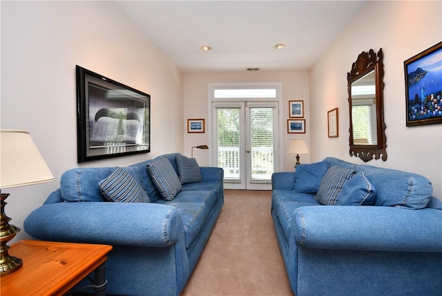 living area featuring recessed lighting, visible vents, and light colored carpet