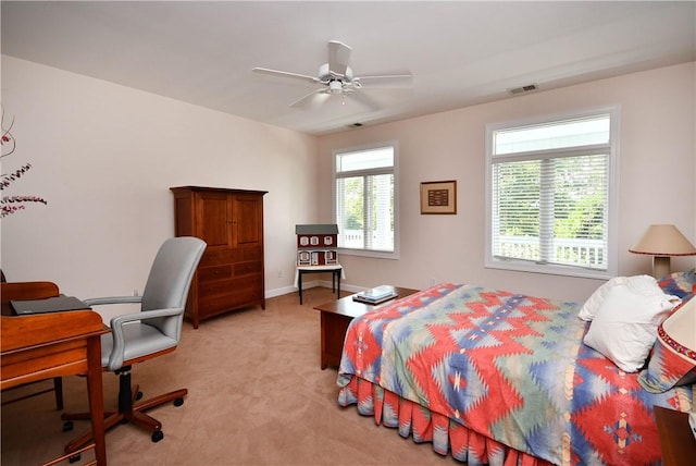 bedroom featuring light colored carpet, visible vents, ceiling fan, and baseboards