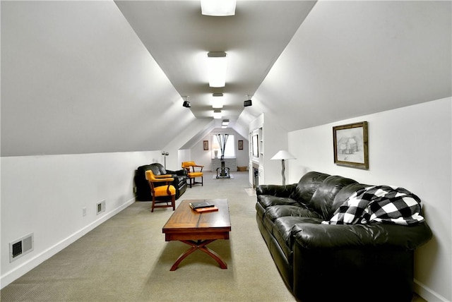 carpeted living room with visible vents, vaulted ceiling, and baseboards