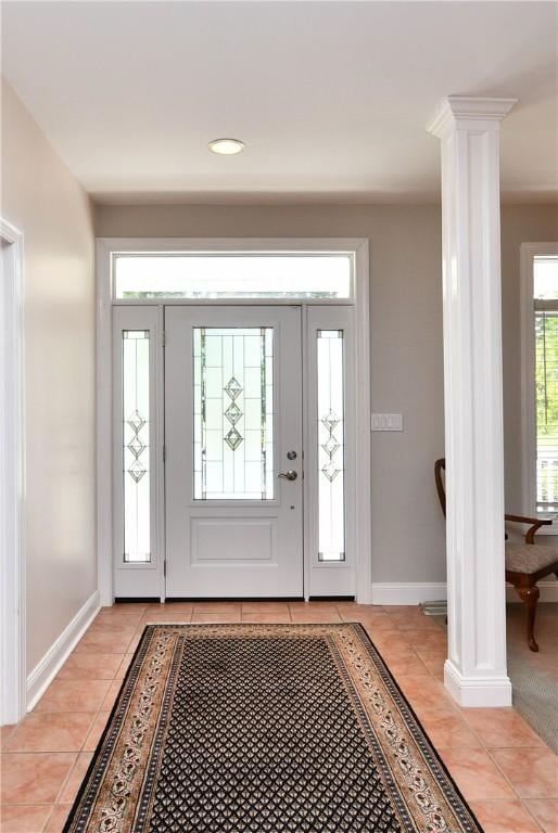 entryway featuring ornate columns, recessed lighting, baseboards, and light tile patterned flooring