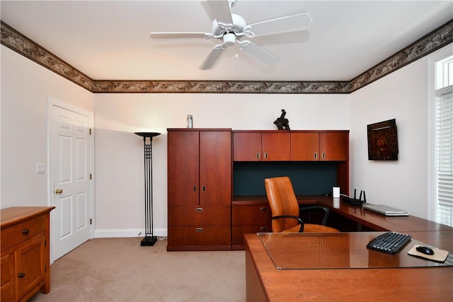 office space with a ceiling fan and light colored carpet