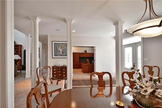 dining space with ornate columns, recessed lighting, french doors, and tile patterned floors