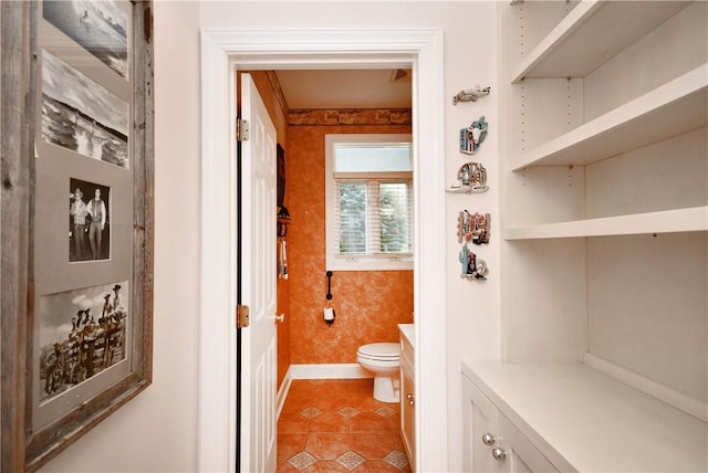 bathroom featuring wallpapered walls, tile patterned flooring, toilet, and baseboards