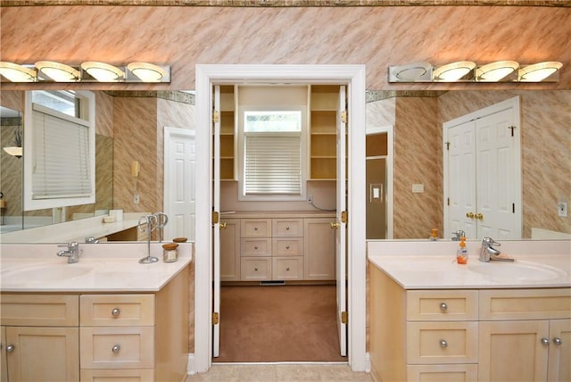 full bathroom with two vanities and a sink