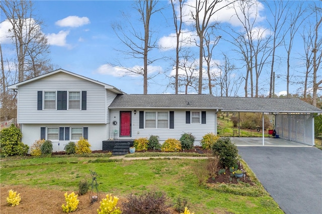 tri-level home with aphalt driveway, a front yard, and a carport