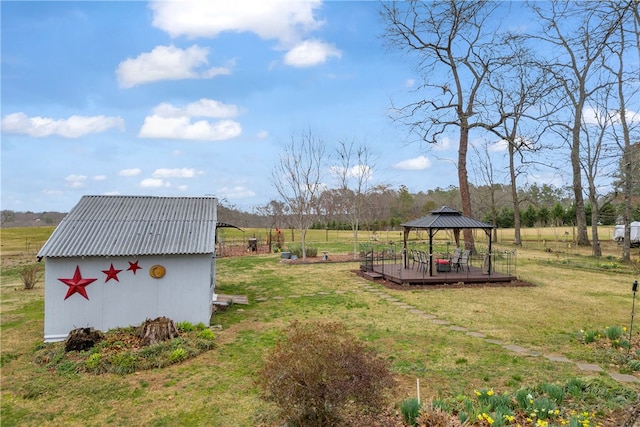 view of yard featuring a storage shed, an outbuilding, and a gazebo