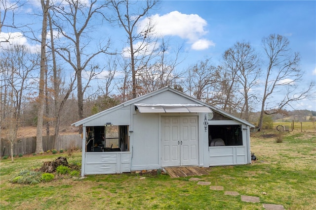 view of outbuilding with an outbuilding and fence