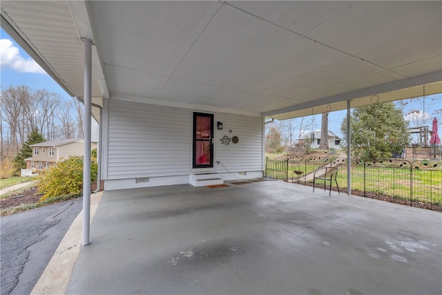 view of patio / terrace featuring an attached carport and fence