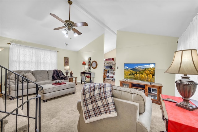 living area featuring vaulted ceiling with beams, carpet flooring, stairs, and a ceiling fan