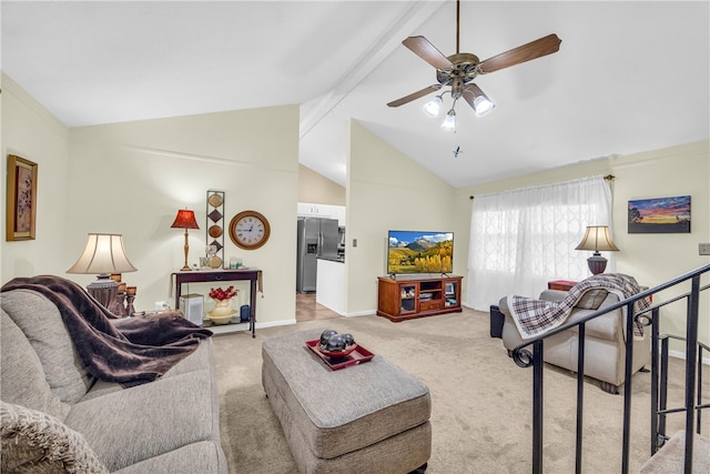 living area with baseboards, beamed ceiling, a ceiling fan, and light colored carpet