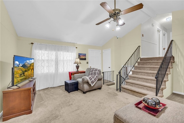 carpeted living room featuring vaulted ceiling with beams, stairway, and ceiling fan