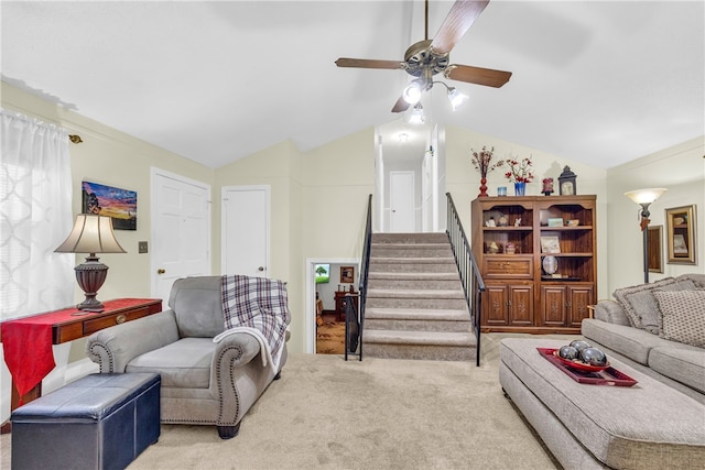 carpeted living room with lofted ceiling, stairway, and a ceiling fan