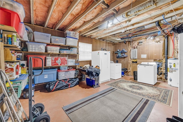 unfinished basement with separate washer and dryer, wood walls, freestanding refrigerator, and electric panel