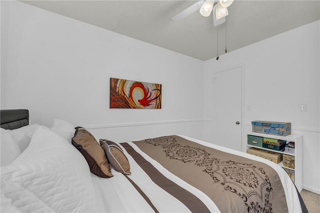 bedroom featuring ceiling fan and carpet