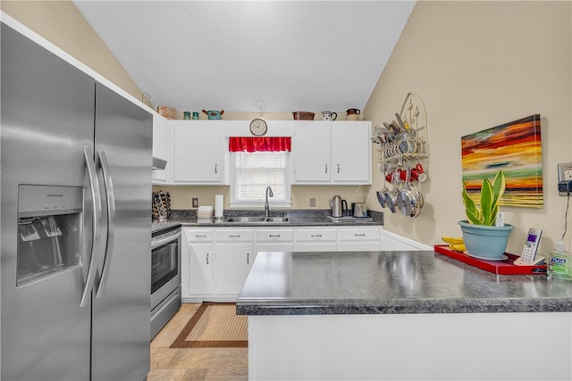 kitchen featuring a sink, white cabinetry, ventilation hood, appliances with stainless steel finishes, and dark countertops