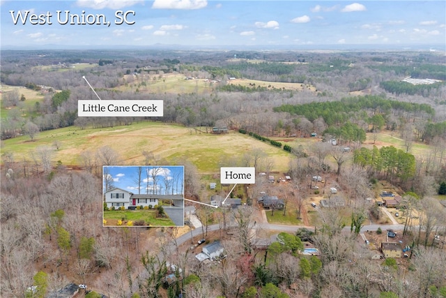 birds eye view of property featuring a rural view