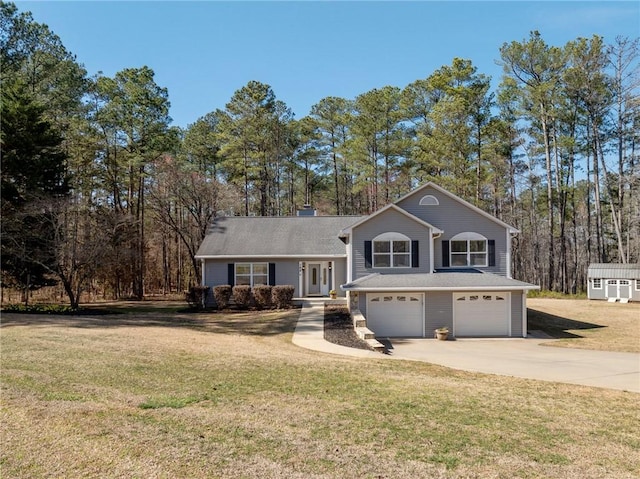 split level home with a garage, driveway, and a front yard