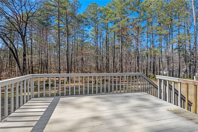 wooden deck with a wooded view