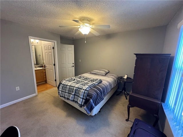 bedroom with a ceiling fan, light carpet, a textured ceiling, and baseboards