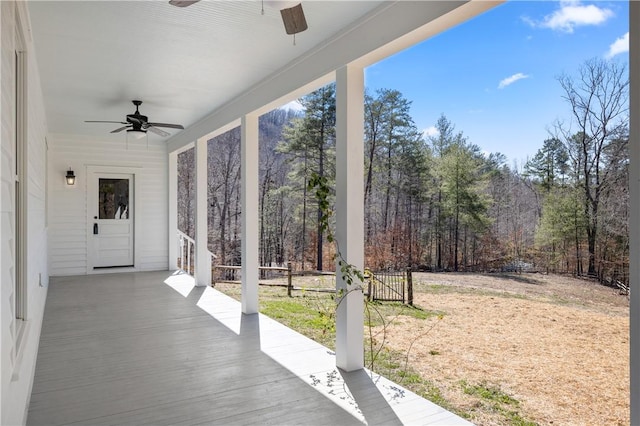 view of patio / terrace with ceiling fan and fence