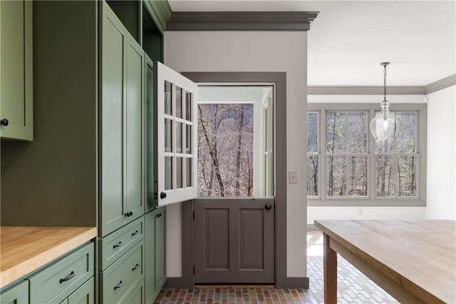 doorway with brick floor and crown molding