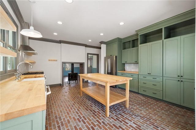 kitchen with green cabinetry, open shelves, and wooden counters