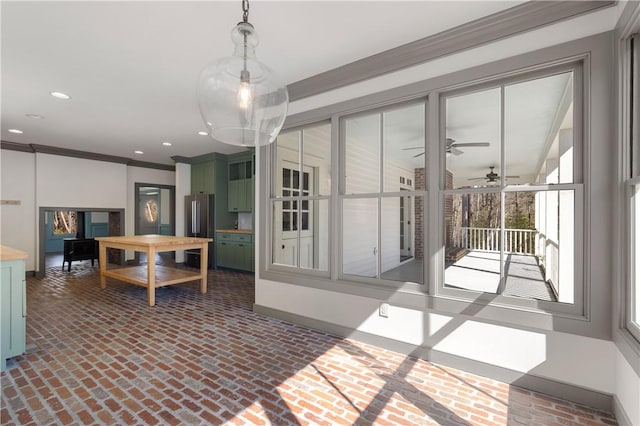dining space with baseboards, recessed lighting, brick floor, ceiling fan, and ornamental molding