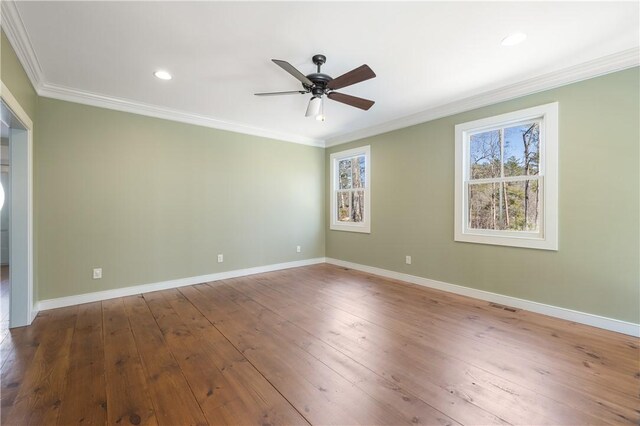 unfurnished room with wood-type flooring, visible vents, ornamental molding, a ceiling fan, and baseboards