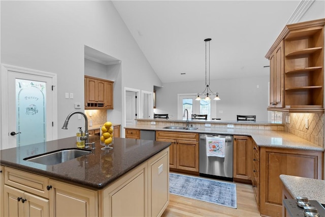 kitchen featuring a sink, a peninsula, open shelves, and stainless steel dishwasher