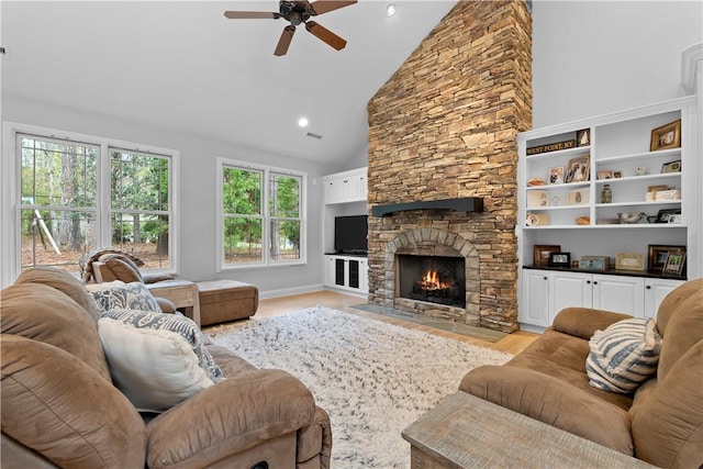 living room with high vaulted ceiling, recessed lighting, a fireplace, a ceiling fan, and light wood finished floors