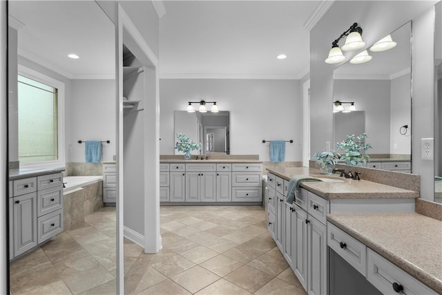 full bath with tiled bath, recessed lighting, two vanities, and crown molding