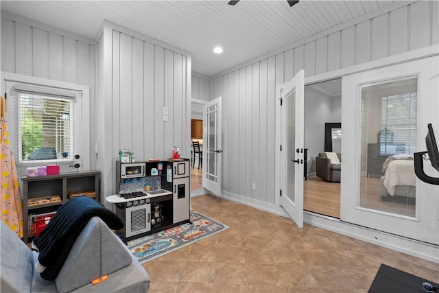 rec room with french doors, ceiling fan, and baseboards