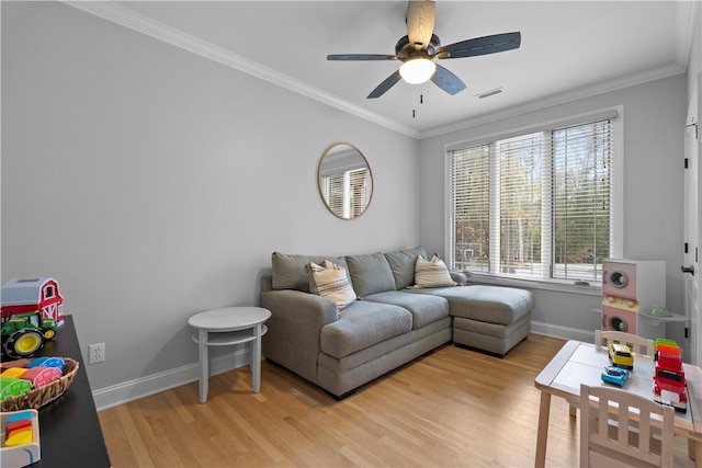 living room with crown molding, visible vents, ceiling fan, light wood-type flooring, and baseboards