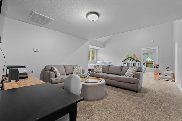 living area featuring lofted ceiling, carpet, visible vents, and a wealth of natural light