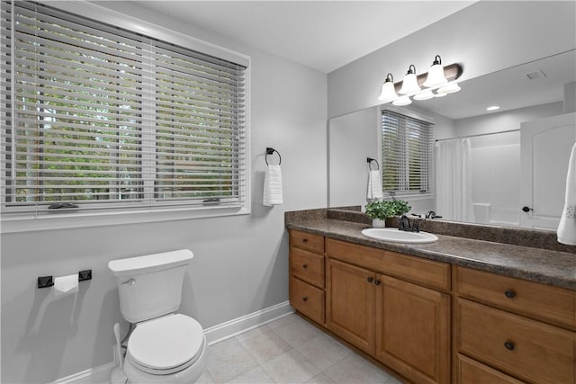 bathroom featuring curtained shower, toilet, vanity, baseboards, and tile patterned floors