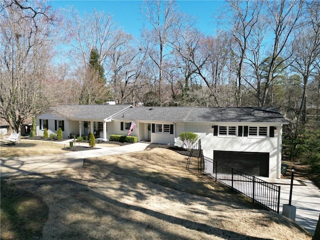 ranch-style house with concrete driveway, an attached garage, and stucco siding