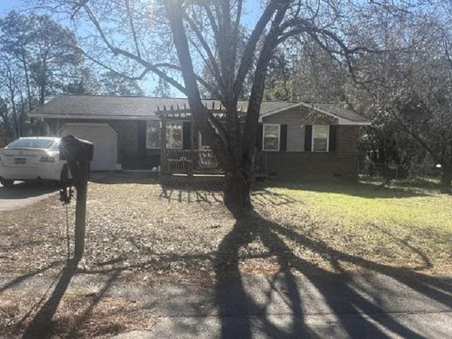 ranch-style home featuring driveway and an attached garage