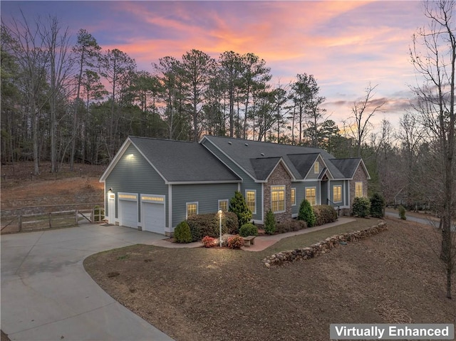 ranch-style house featuring a garage, a gate, fence, and driveway