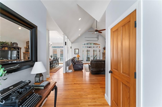 foyer featuring lofted ceiling, ceiling fan, light wood finished floors, and recessed lighting